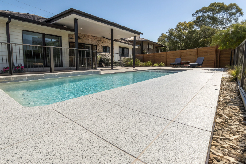 Non-slip epoxy pool deck coating installed around residential swimming pool in Newcastle coastal property